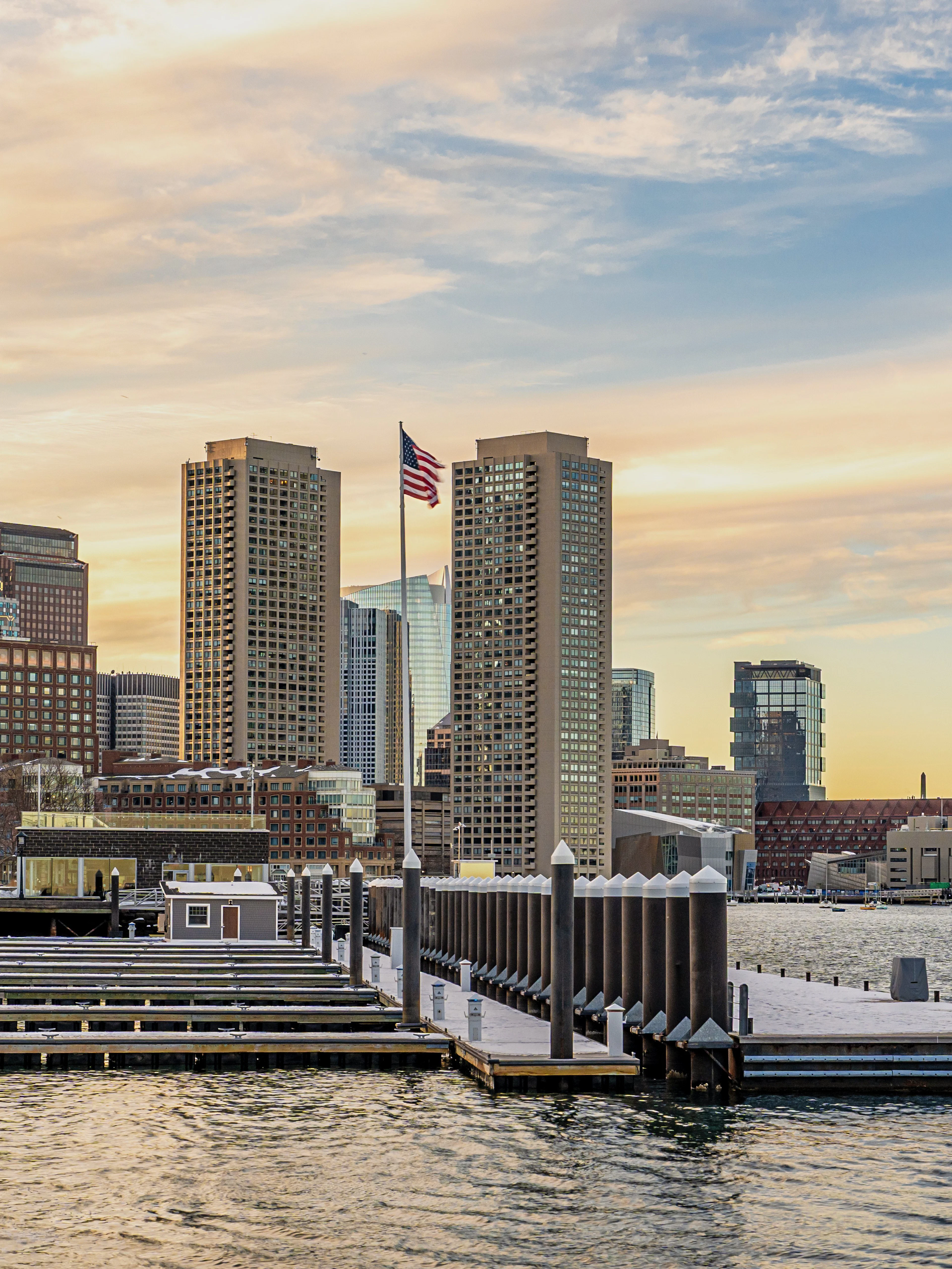 Boston downtown skyscrapers viewed from Seaport District on a winter evening.