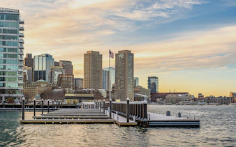 Boston downtown skyscrapers viewed from Seaport District on a winter evening.