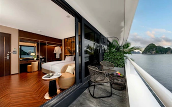 Deluxe double room with balcony view of Ha Long Bay on 6-star luxury cruise.
