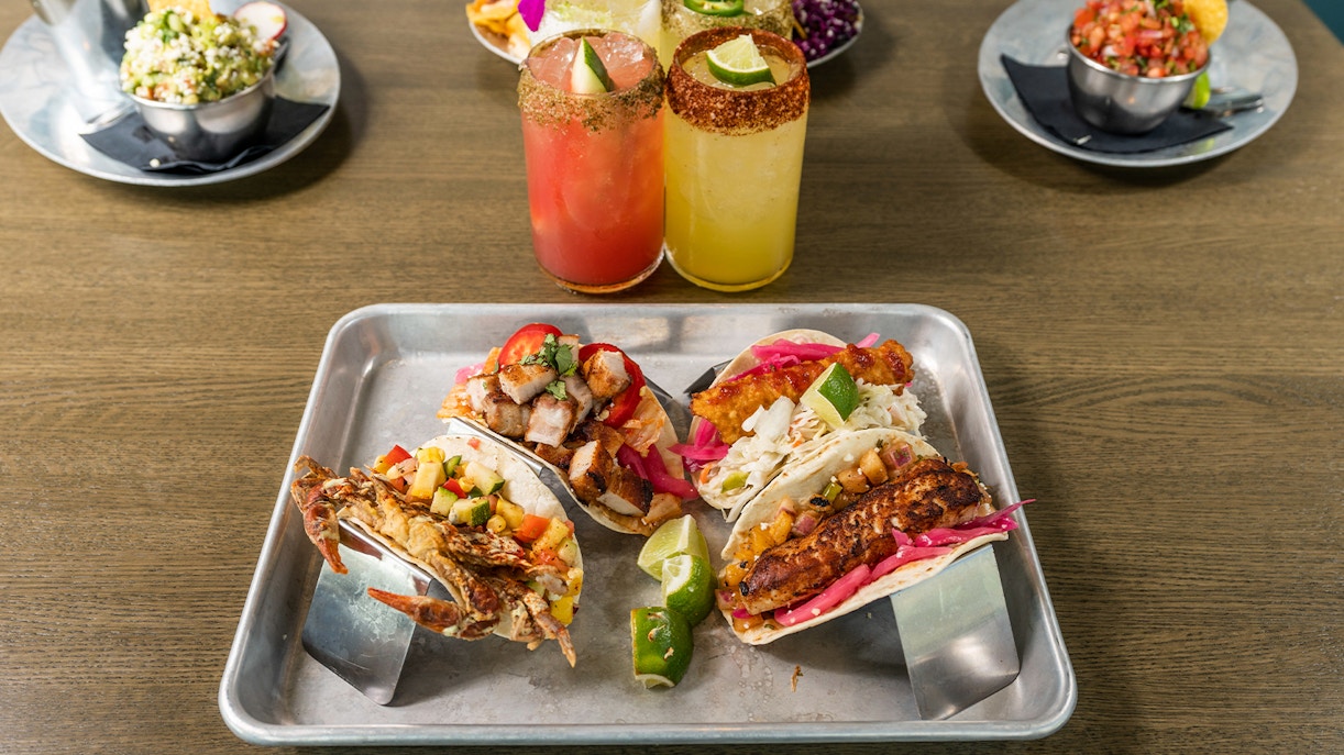 Traditional Mexican dishes with vibrant ingredients on a wooden table in Mexico City.