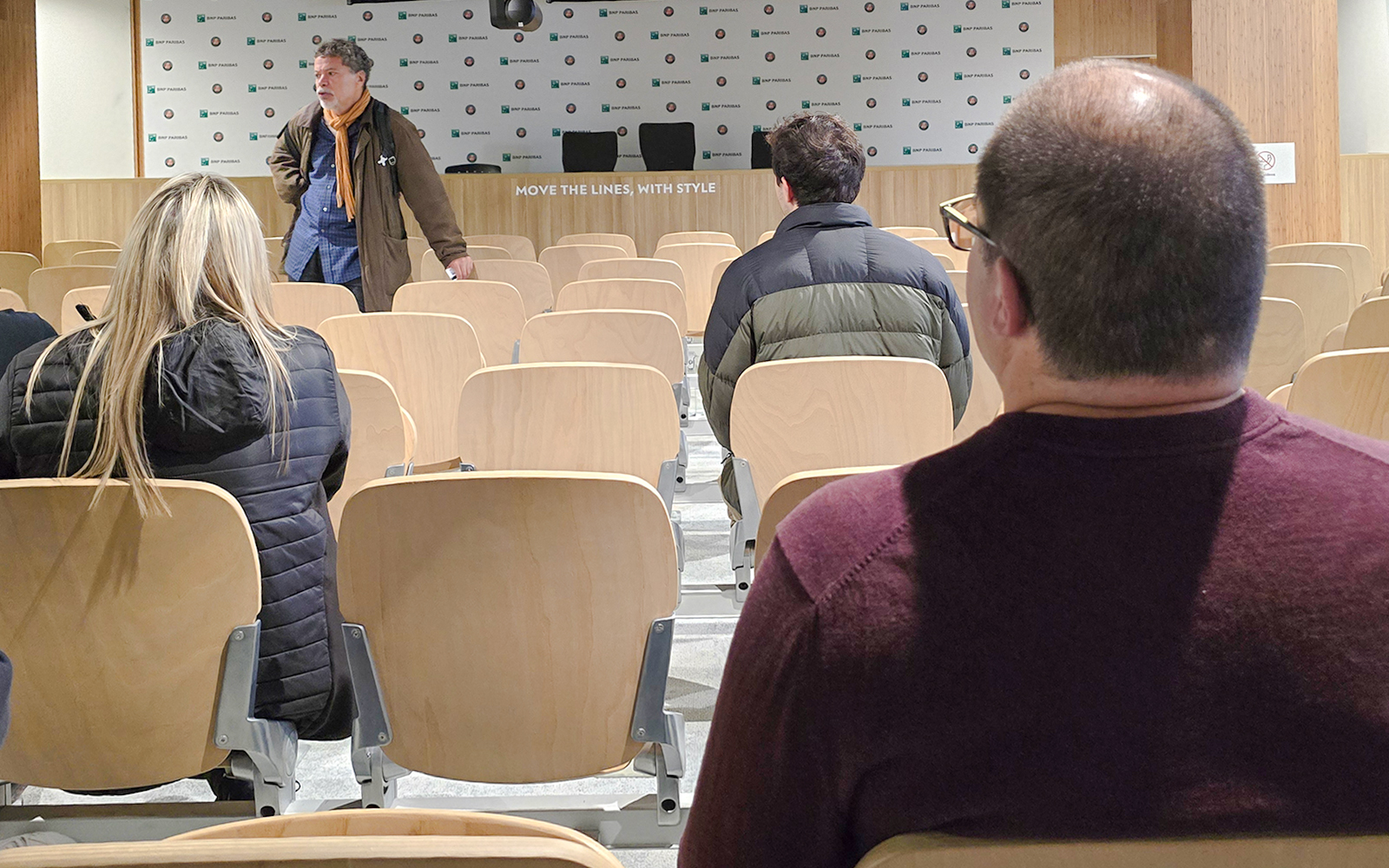Audience seated in Roland-Garros press room with speaker at front.