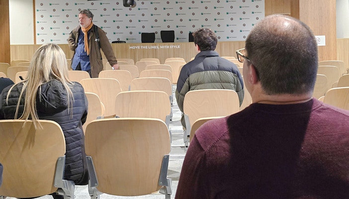 Audience seated in Roland-Garros press room with speaker at front.