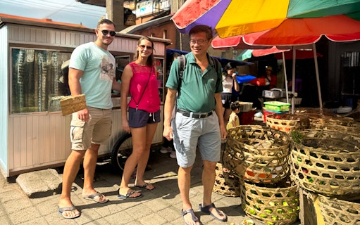 Tourists exploring a local market in Ubud during the Jambangan Bali Cooking Class.