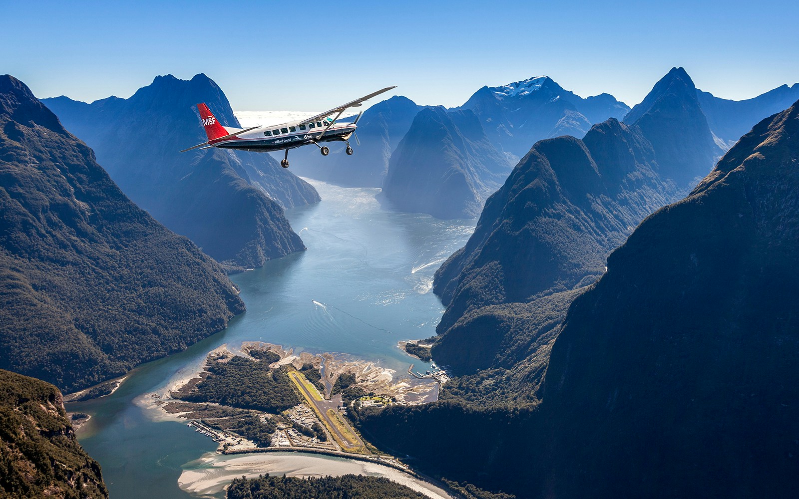 Milford Sound aerial view with cruise ship, Queenstown scenic flyover experience.