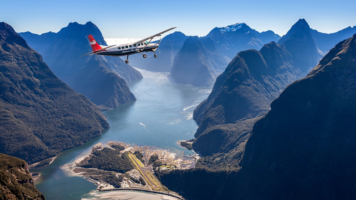 Milford Sound aerial view with cruise ship, Queenstown scenic flyover experience.