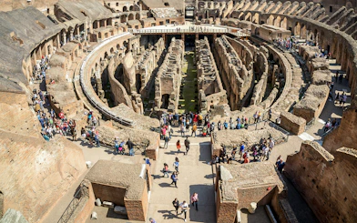 Visitors exploring the first floor of the Colosseum in Rome, Italy.