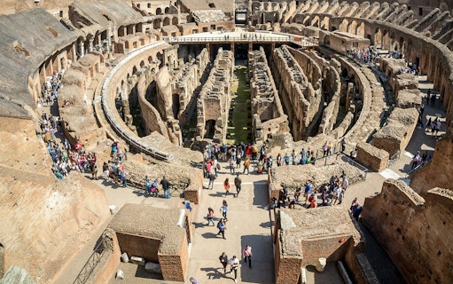 Visitors exploring the first floor of the Colosseum in Rome, Italy.