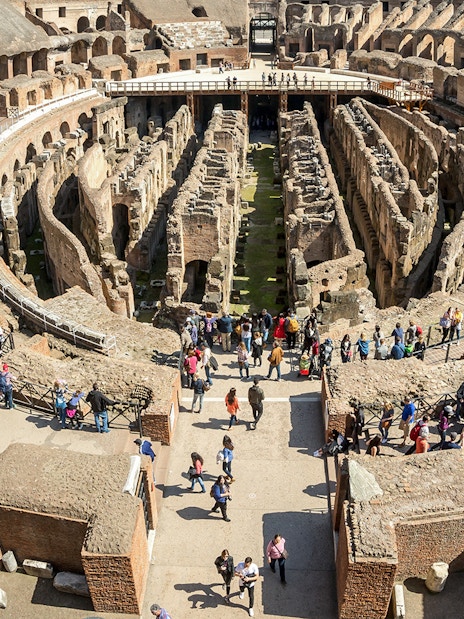 Visitors exploring the first floor of the Colosseum in Rome, Italy.