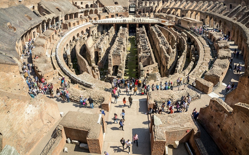 Visitors exploring the first floor of the Colosseum in Rome, Italy.