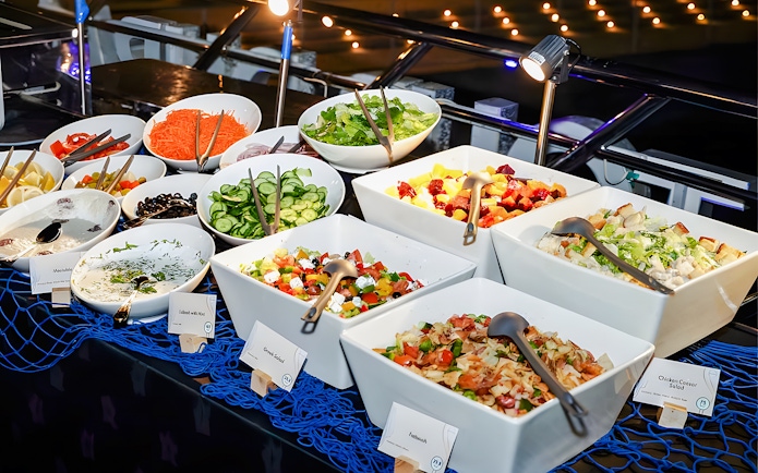 Buffet spread on 2-hour luxury dhow dinner cruise in Dubai featuring salads and appetizers.