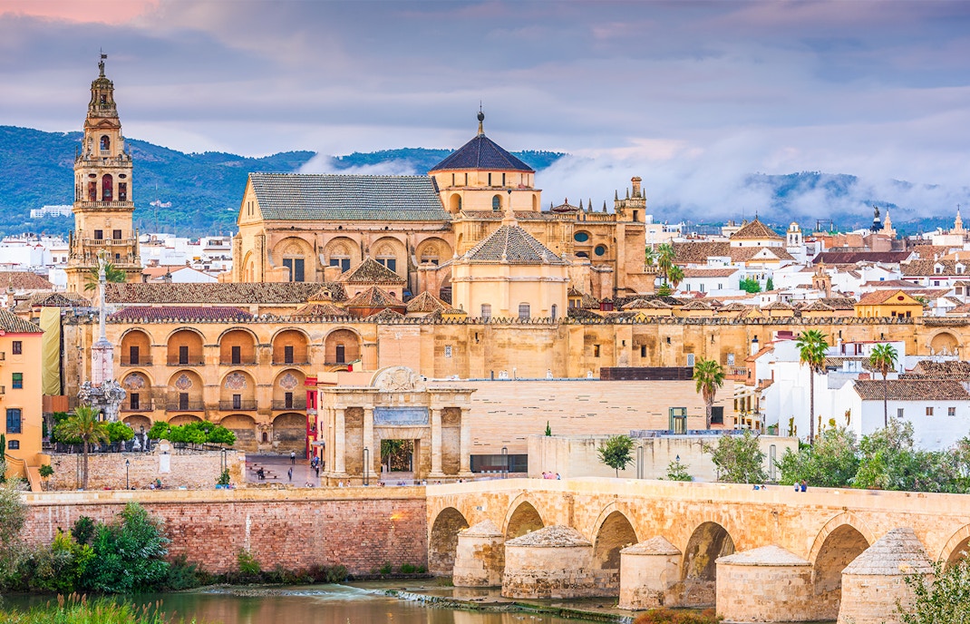 Cordoba Mosque-Cathedral with Roman Bridge in foreground, Spain.