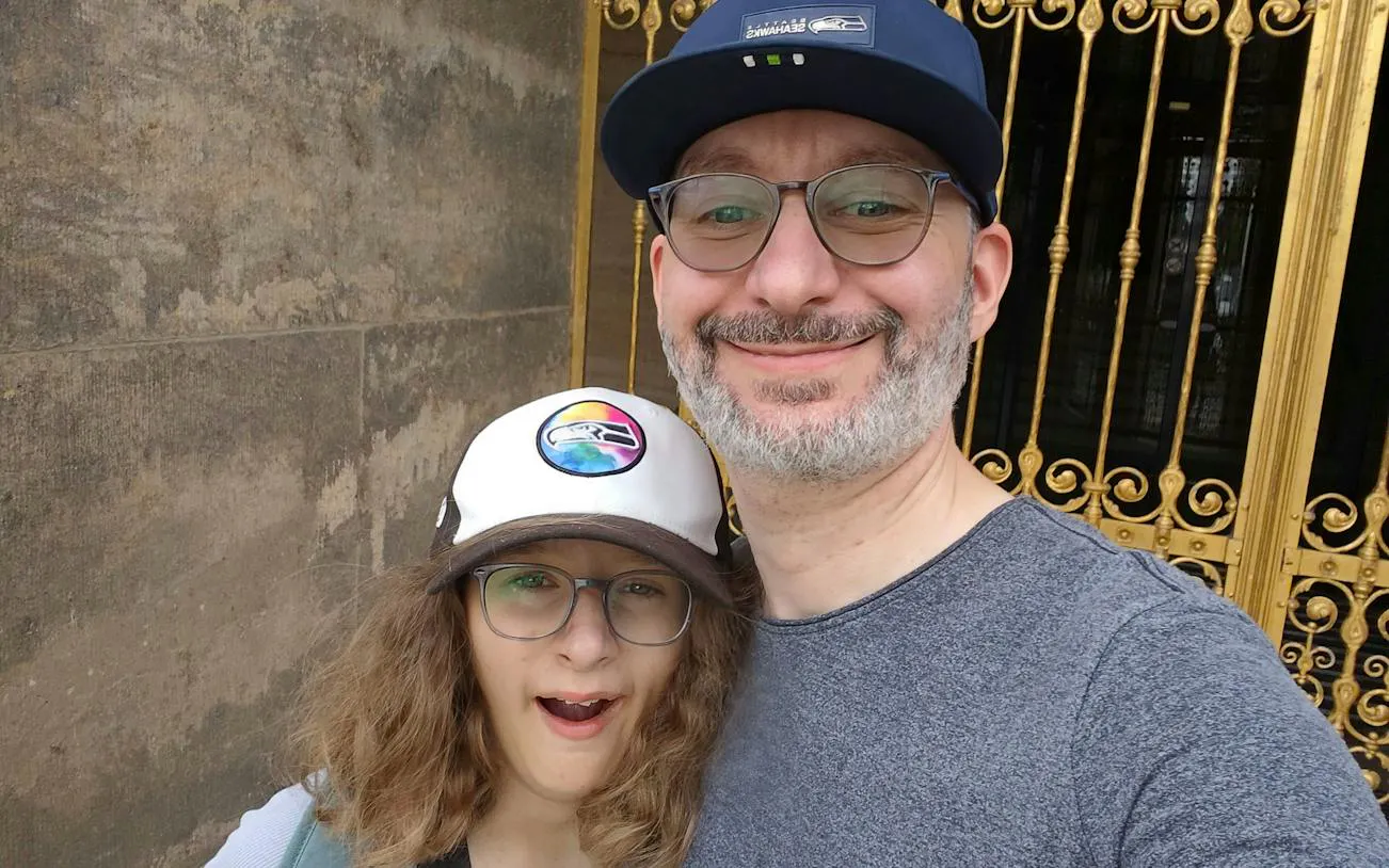 Visitors in front of ornate golden gate during Dresden city exploration game.