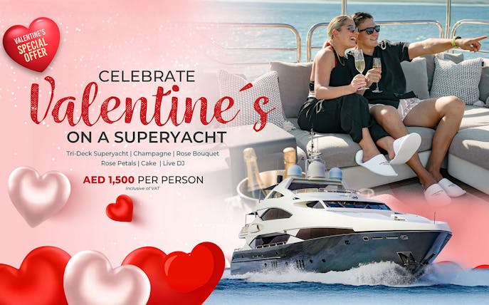 Valentine's Day yacht celebration with champagne, rose petals, cake, and live DJ.