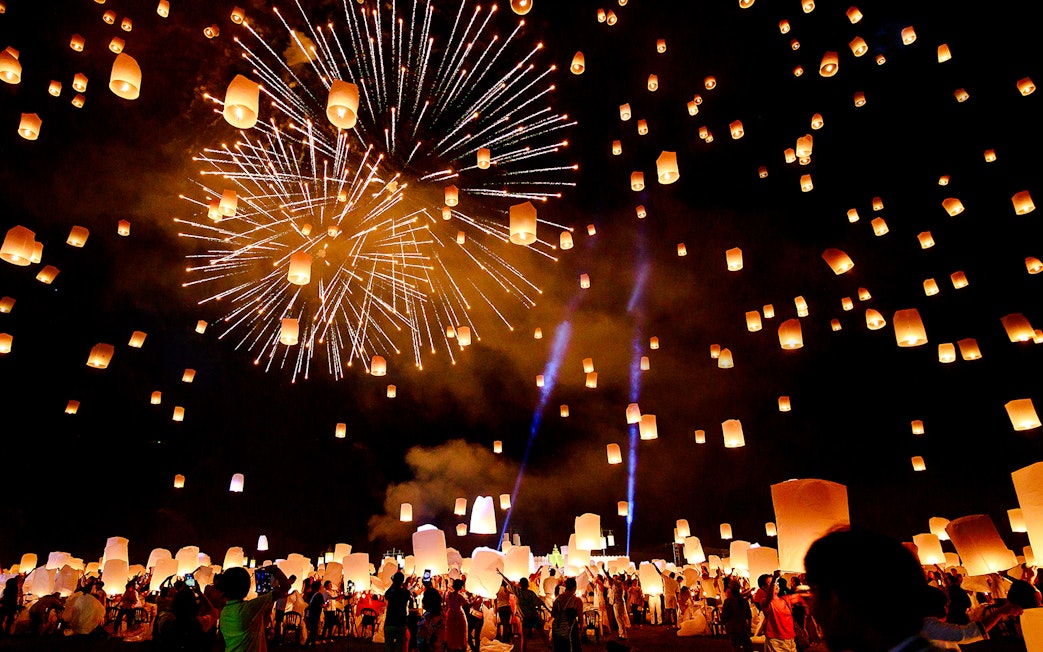 Sky lanterns and fireworks illuminate the night at Chiang Mai Sky Lanterns Festival.