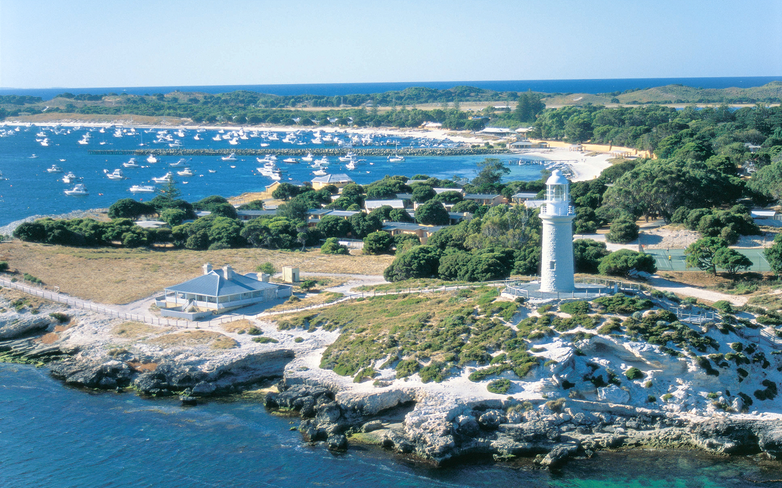 Rottnest Island lighthouse overlooking bay with numerous boats.