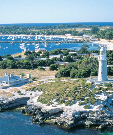 Rottnest Island lighthouse overlooking bay with numerous boats.