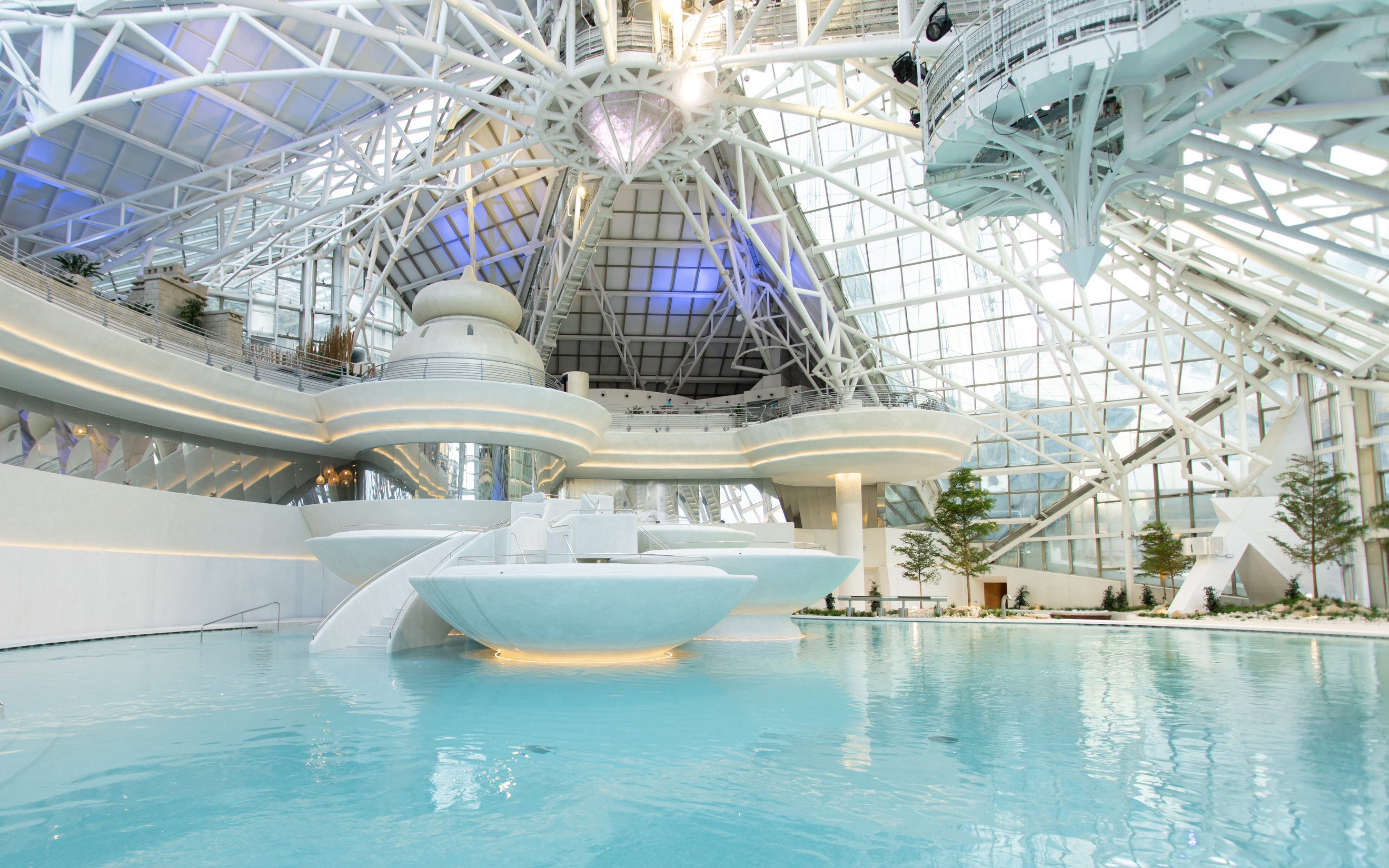 Main lagoon at Caldea thermal spa, Andorra, with modern architecture and clear blue water.