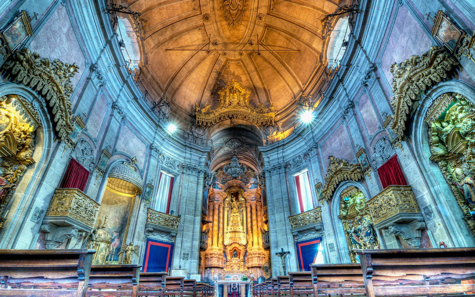 Clerigos Tower interior with ornate altar and wooden pews, Porto, Portugal.