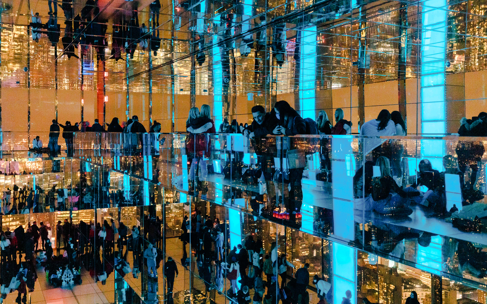 Guests enjoying mirrored observation deck at Summit One Vanderbilt, New York City, at night.