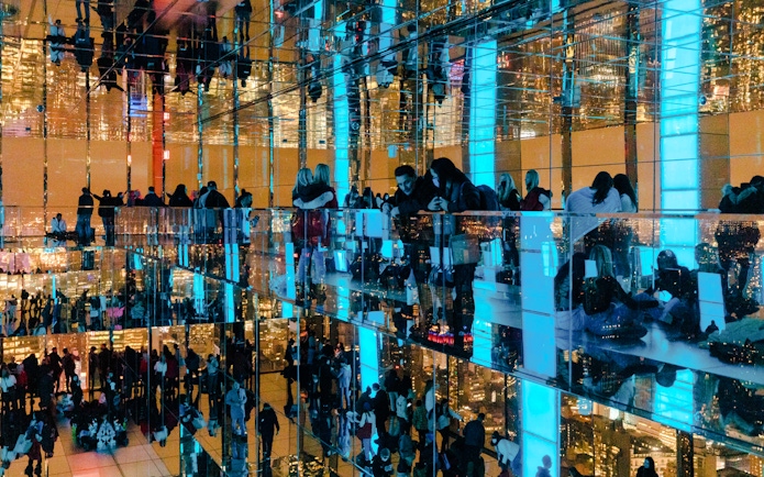 Guests enjoying mirrored observation deck at Summit One Vanderbilt, New York City, at night.
