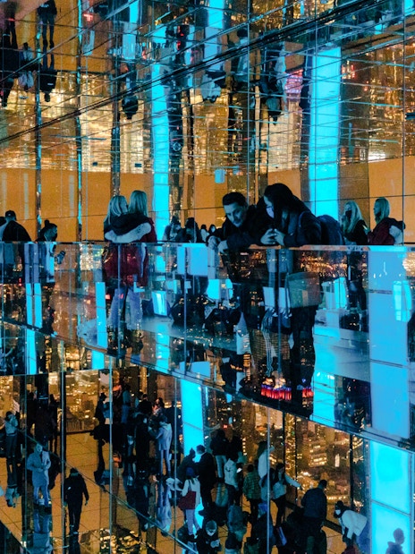 Guests enjoying mirrored observation deck at Summit One Vanderbilt, New York City, at night.