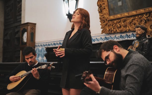 Fado performance with musicians at São Bento da Vitória Monastery, Porto.