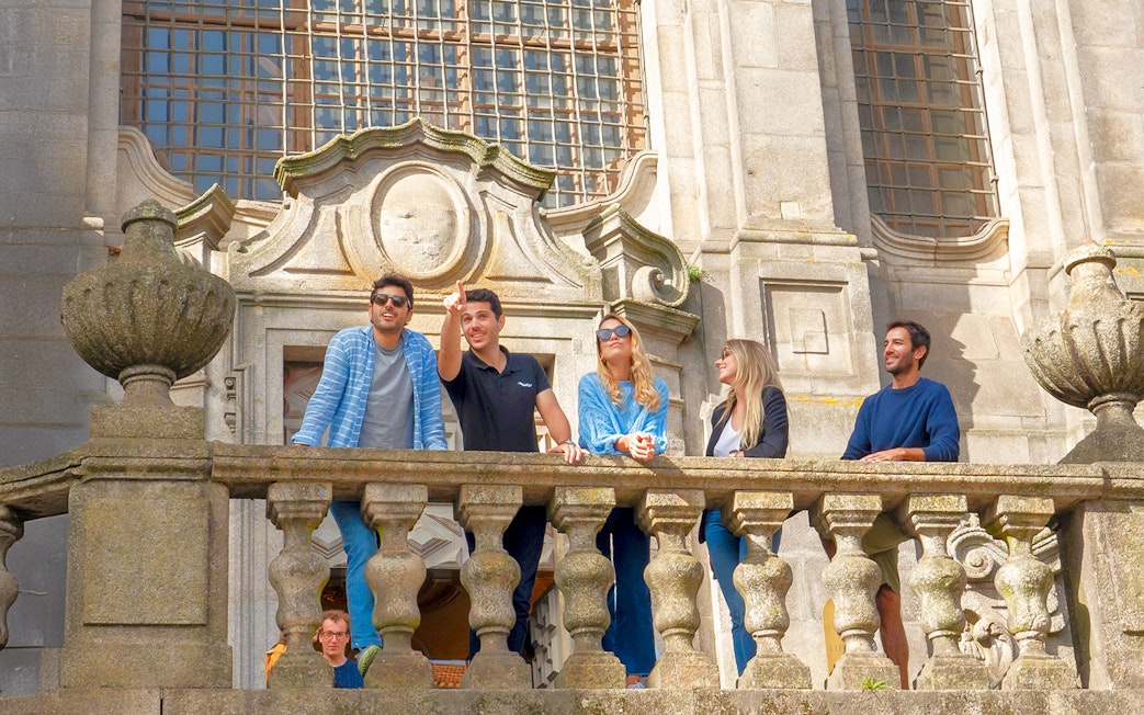 Tourists enjoying the view from a church viewpoint during a Porto walking tour.
