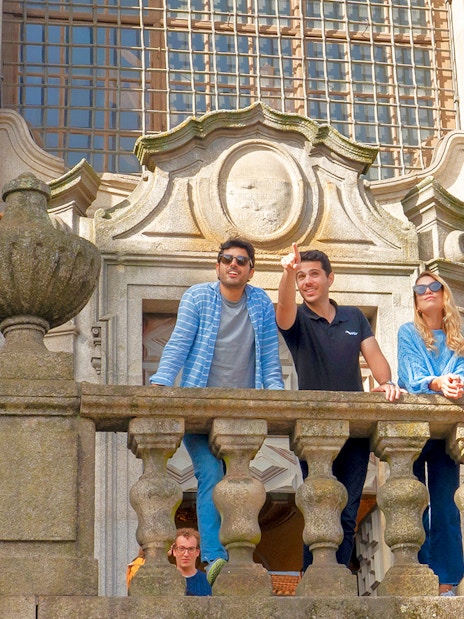 Tourists enjoying the view from a church viewpoint during a Porto walking tour.