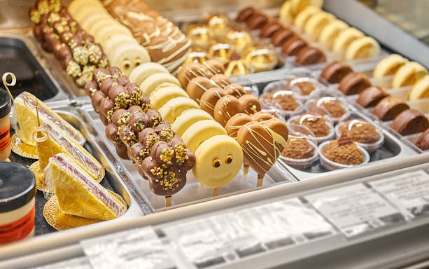 Italian cafe dessert display with chocolate and vanilla treats.