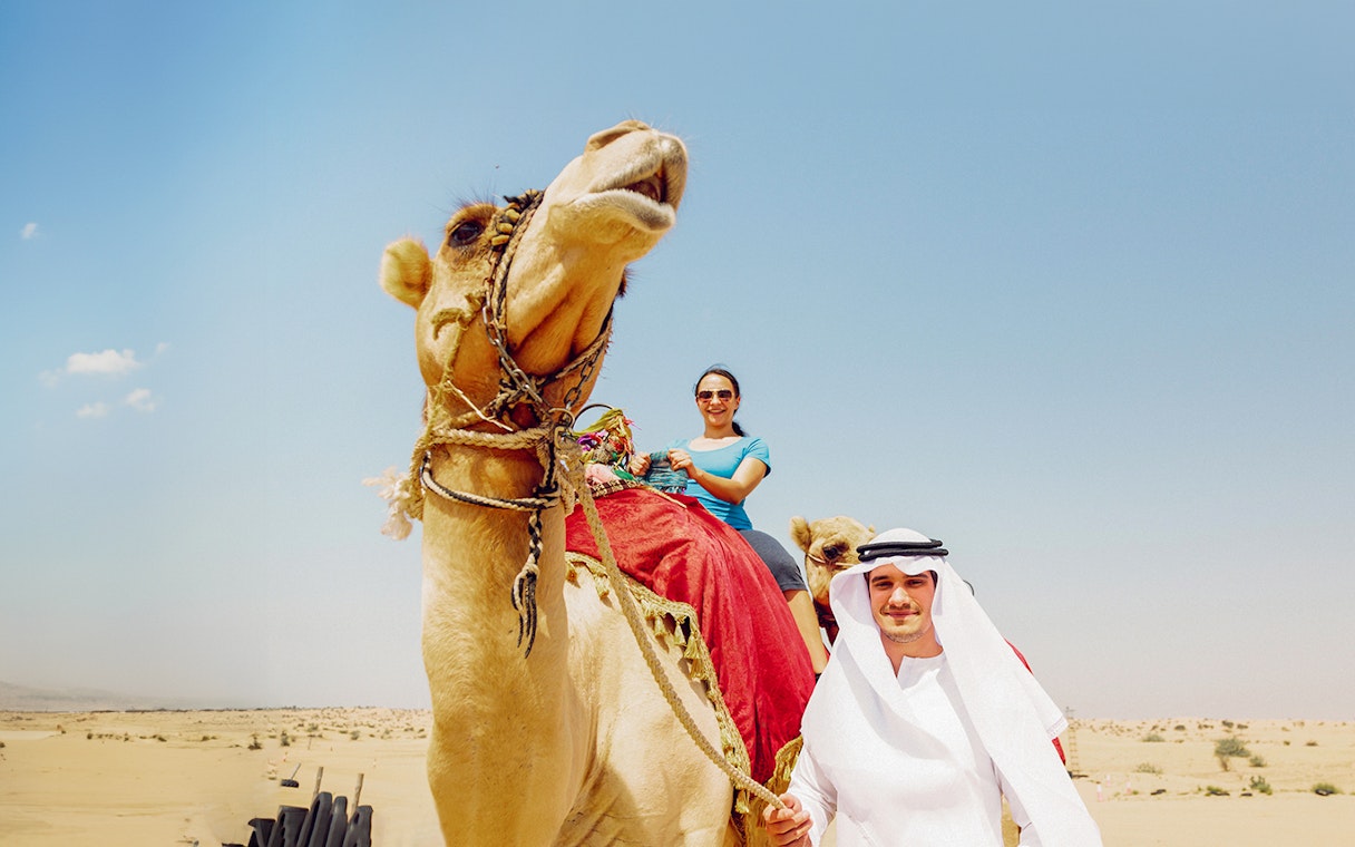 Lady on camel during desert safari, Abu Dhabi.