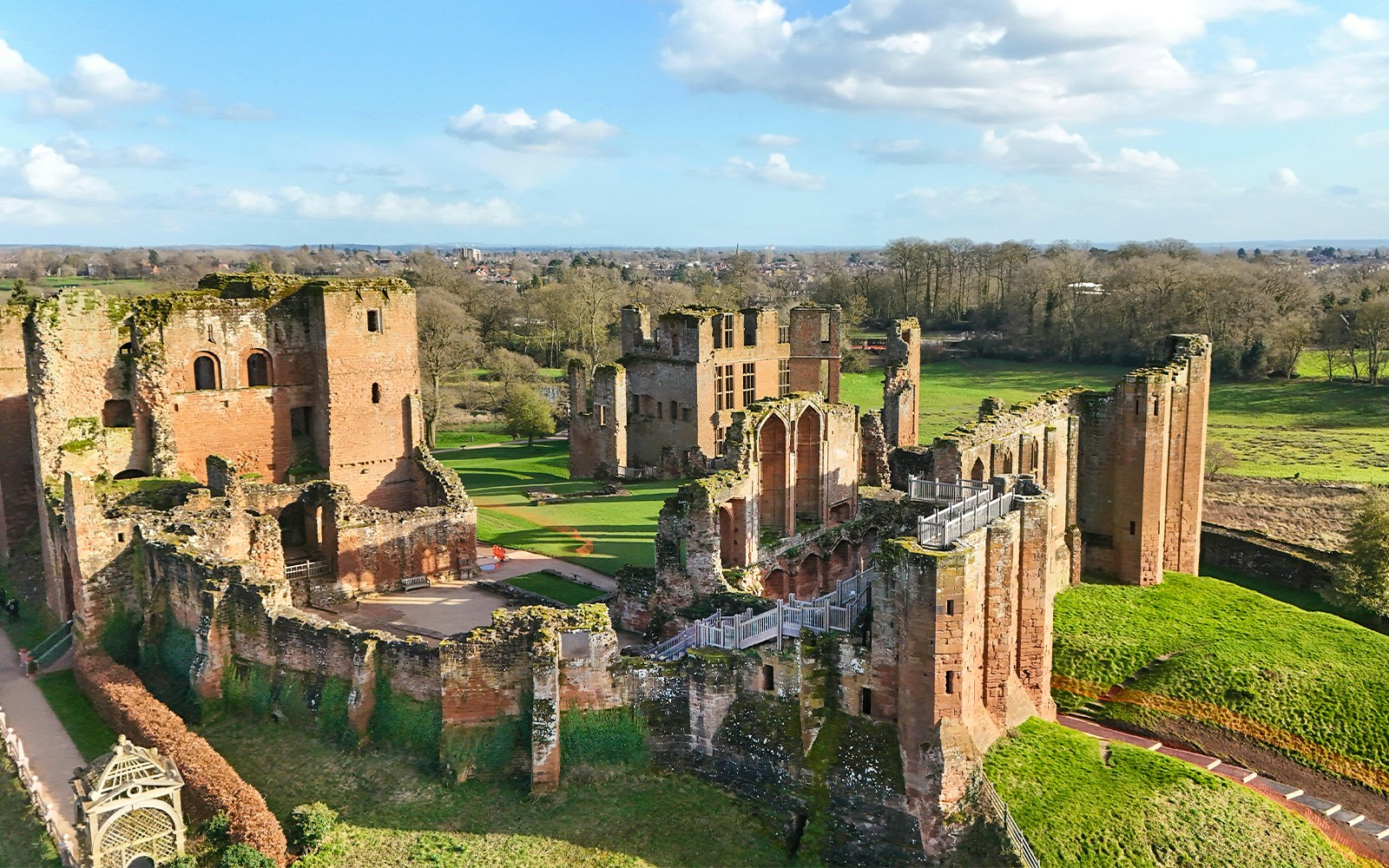 Kenilworth Castle ruins with lush green landscape in Warwickshire, England.