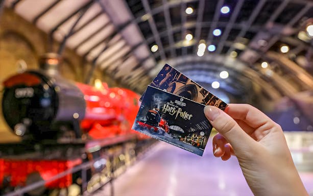 Tickets held in front of the Hogwarts Express at the Harry Potter Exhibit.