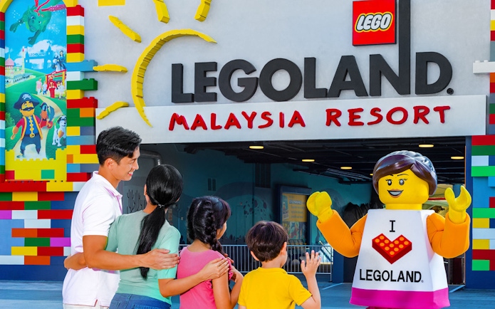 Family meeting LEGO character at Legoland Malaysia Resort entrance