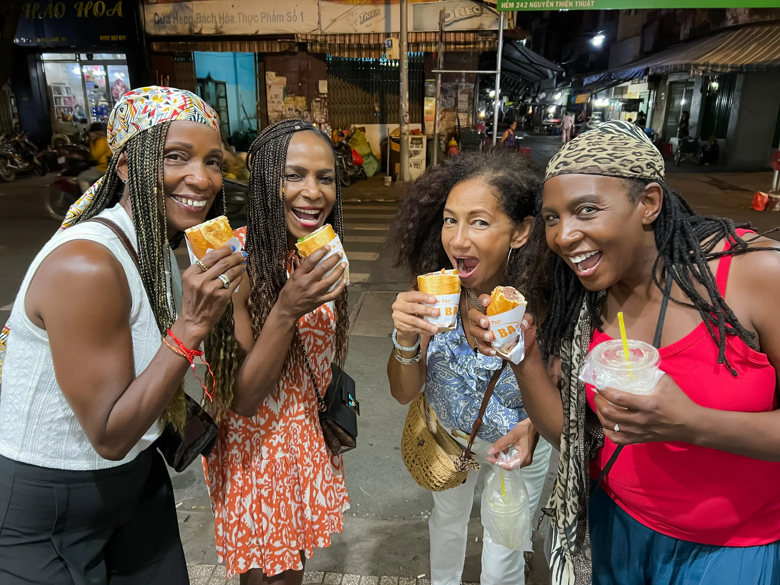 Group enjoying bánh mì on a street food tour in Saigon, Ho Chi Minh City.