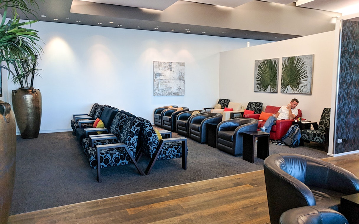 Plaza Premium Lounge seating area with armchairs and modern decor.