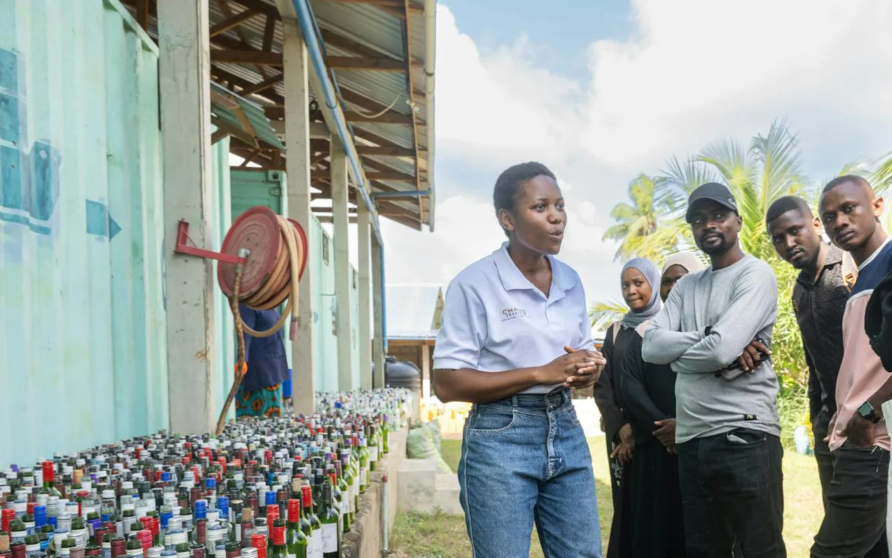 Guide explaining upcycling process to group during Zanzibar Stone Town Walking Tour.