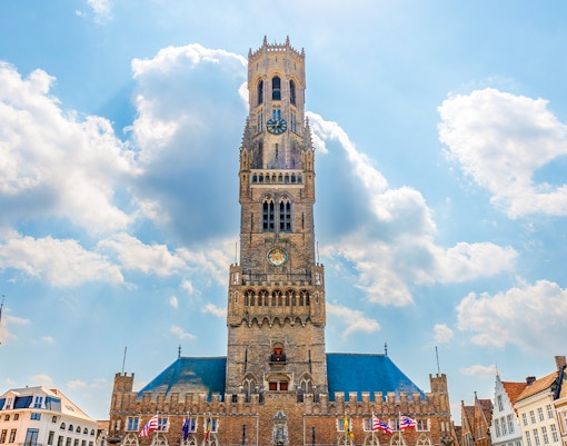 Historium Brugge facade with medieval architecture and tourists exploring the entrance.