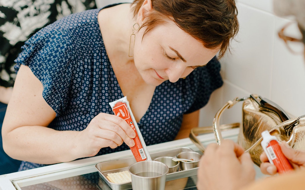 Guest mixing ingredients during interactive dining at Wonderland Upside Down.