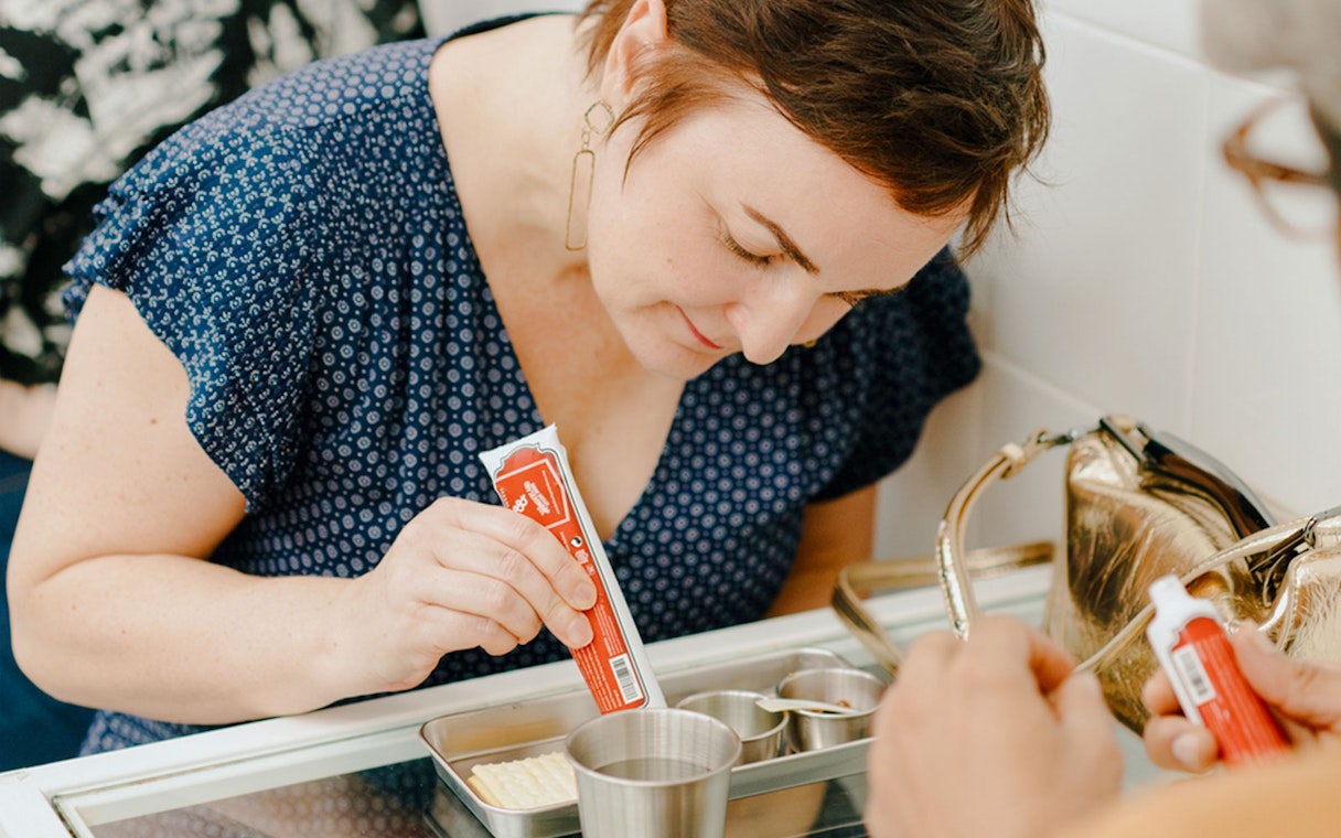 Guest mixing ingredients during interactive dining at Wonderland Upside Down.