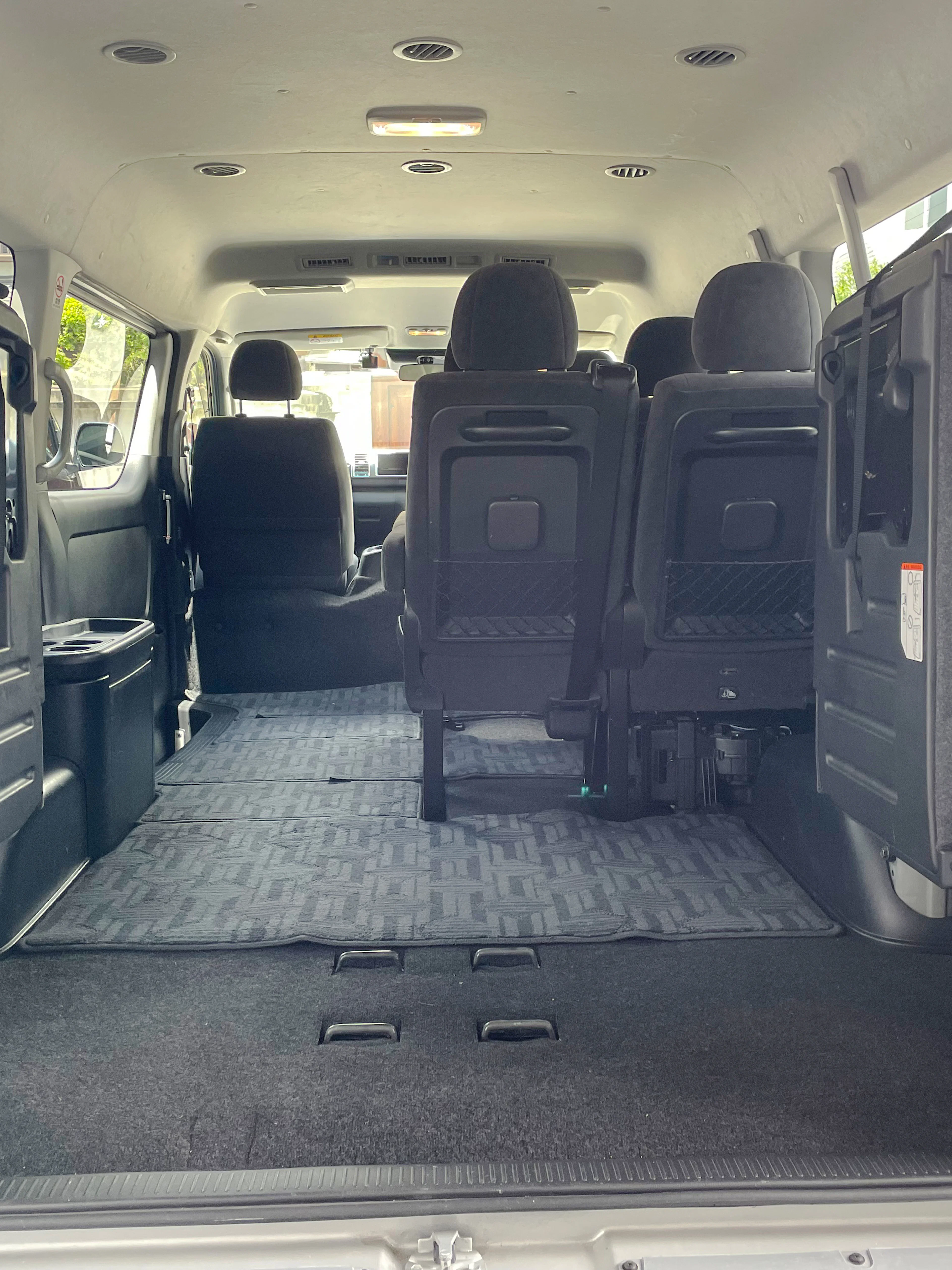 Interior of a spacious van for private transfer between Kansai Airport and Osaka.