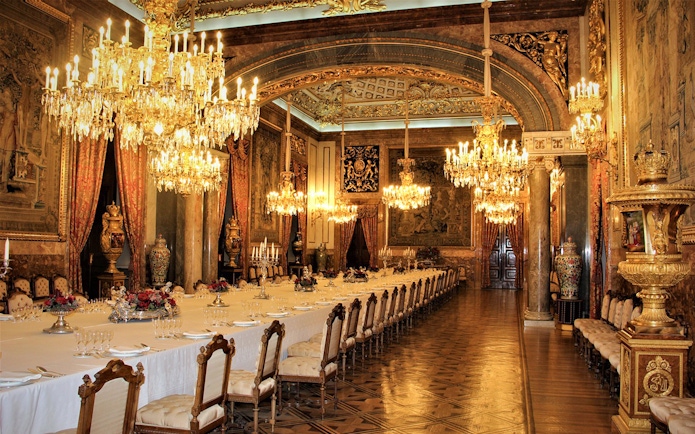 Royal dining room with chandeliers and ornate decor, Royal Palace of Madrid state room.