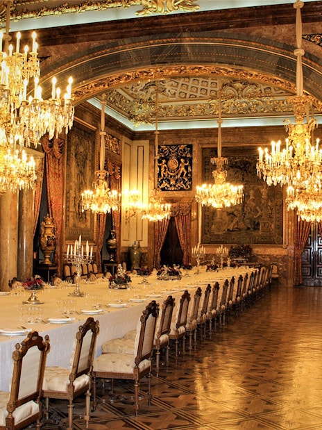 Royal dining room with chandeliers and ornate decor, Royal Palace of Madrid state room.