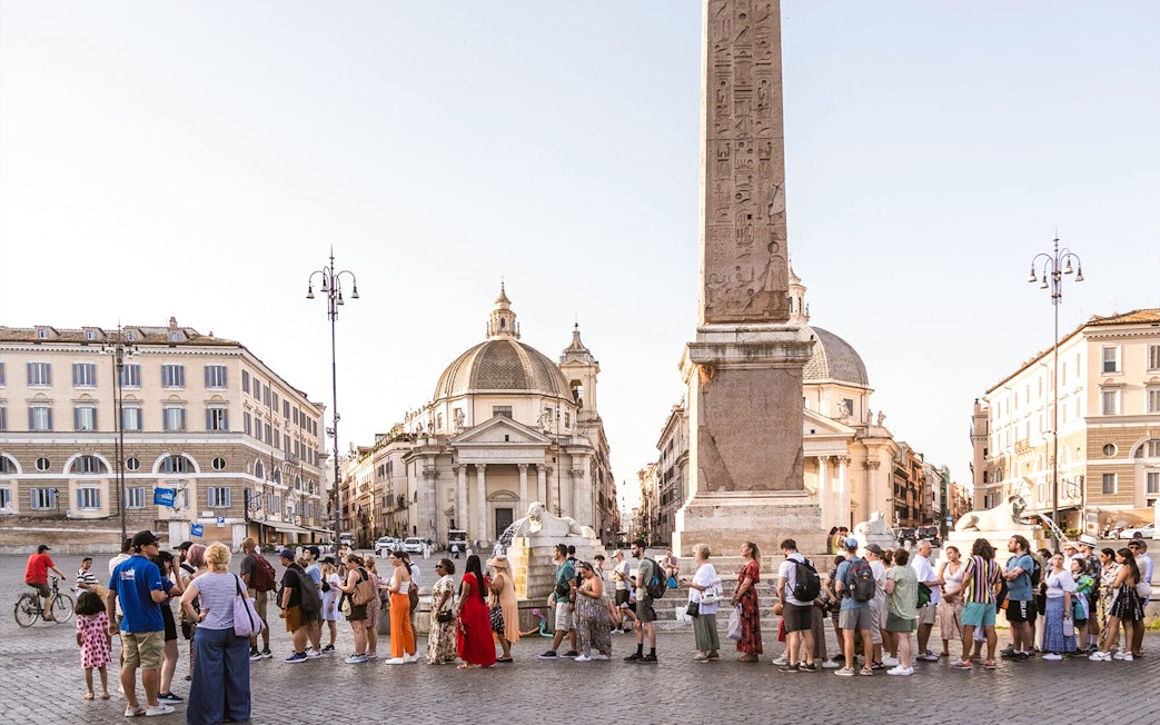 Tourists gathered at Piazza Navona, Rome, near the central obelisk and fountain.