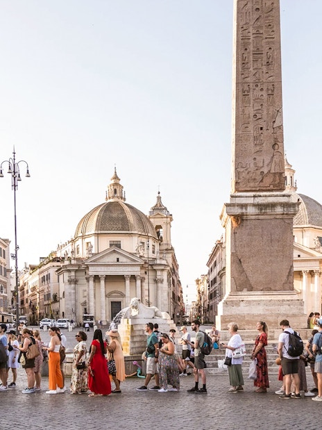 Tourists gathered at Piazza Navona, Rome, near the central obelisk and fountain.