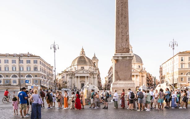 Tourists gathered at Piazza Navona, Rome, near the central obelisk and fountain.