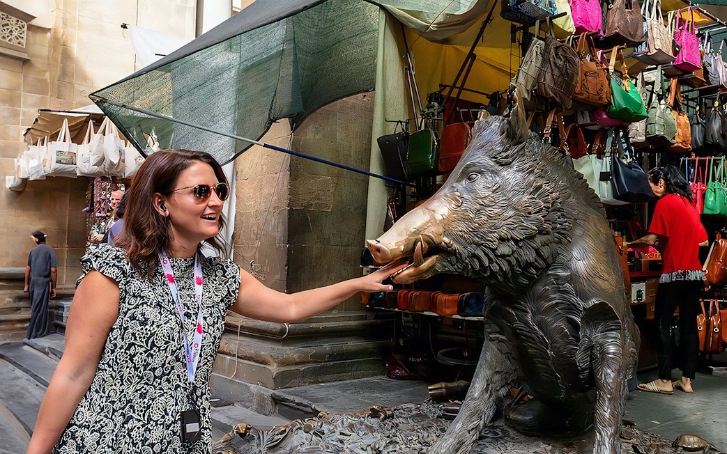 Woman touching Il Porcellino statue on Florence walking tour.