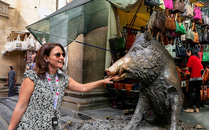 Woman touching Il Porcellino statue on Florence walking tour.