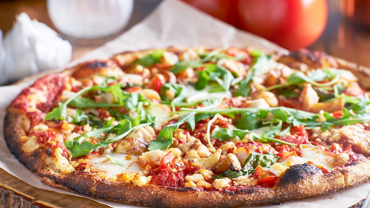 Wood-fired pizza with fresh toppings served at a restaurant near the Acropolis in Athens.