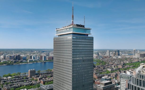 Prudential Tower in Boston with city skyline and Charles River in view.