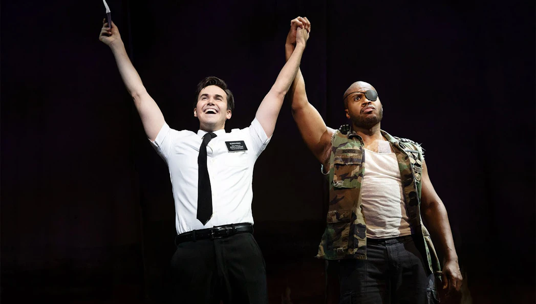 Actors on stage during The Book of Mormon Broadway performance.